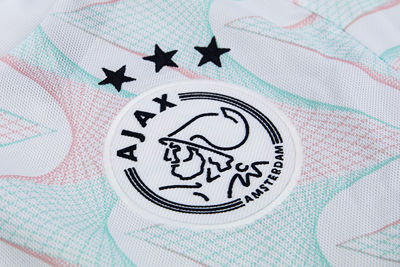 Ajaxlogo in donkerblauw op een witte badge. © Ajax Life